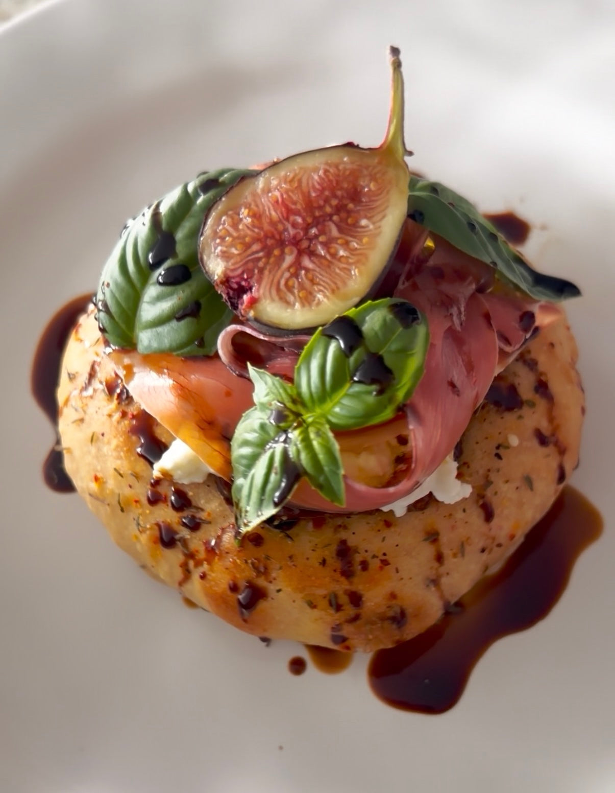 Za’atar Bialy with Prosciutto, Buratta, & Fig Jam