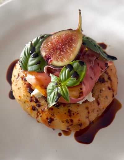 Za’atar Bialy with Prosciutto, Buratta, & Fig Jam
