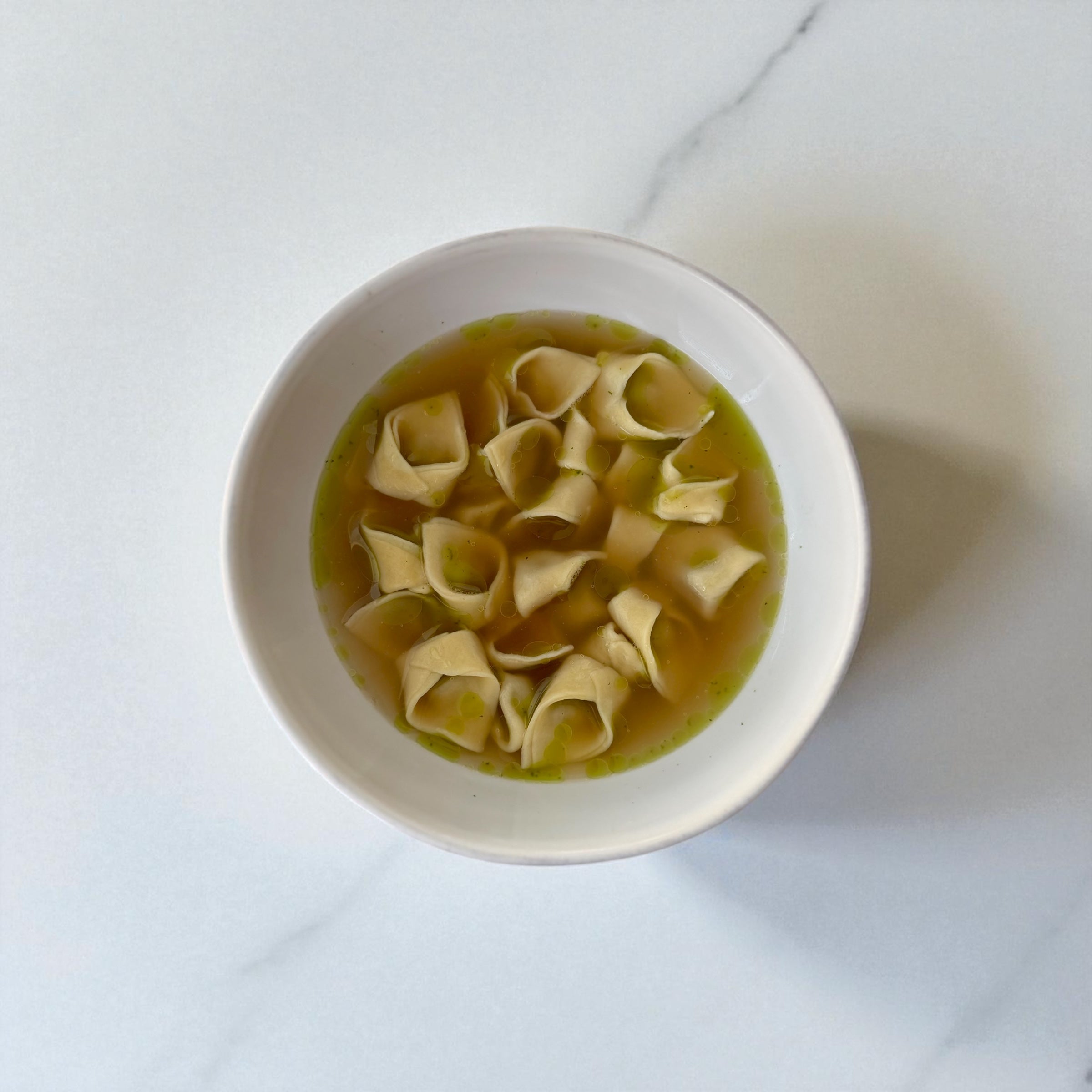 Spiced Lamb Cappelletti en Brodo with Herb Oil